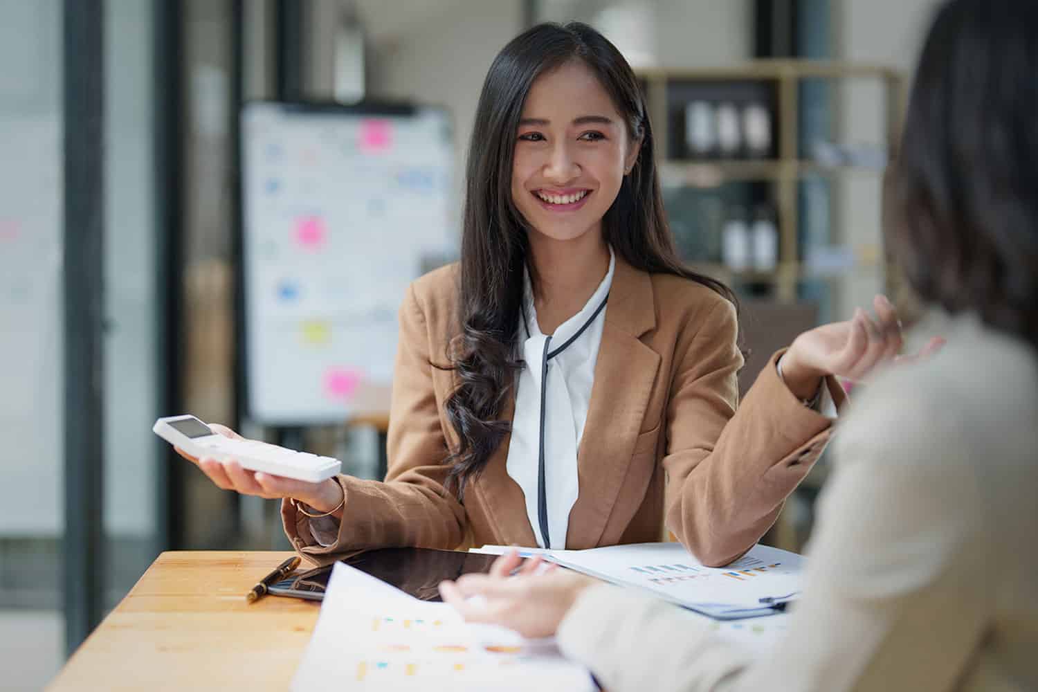 A finance team member smiles as productivity increases with an expense management system.