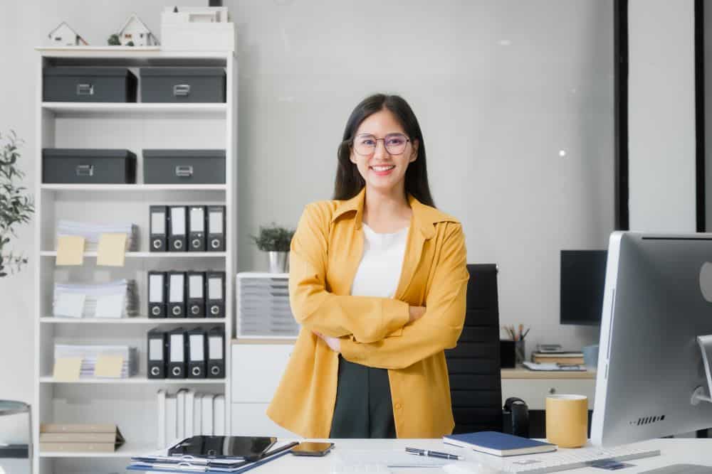 A smiling young woman at an HR outsourcing company in Singapore.