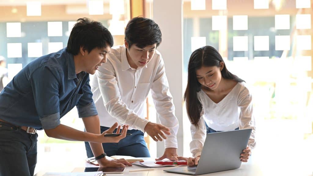 HR and payroll team reviewing aligned employee data in a Singapore office.