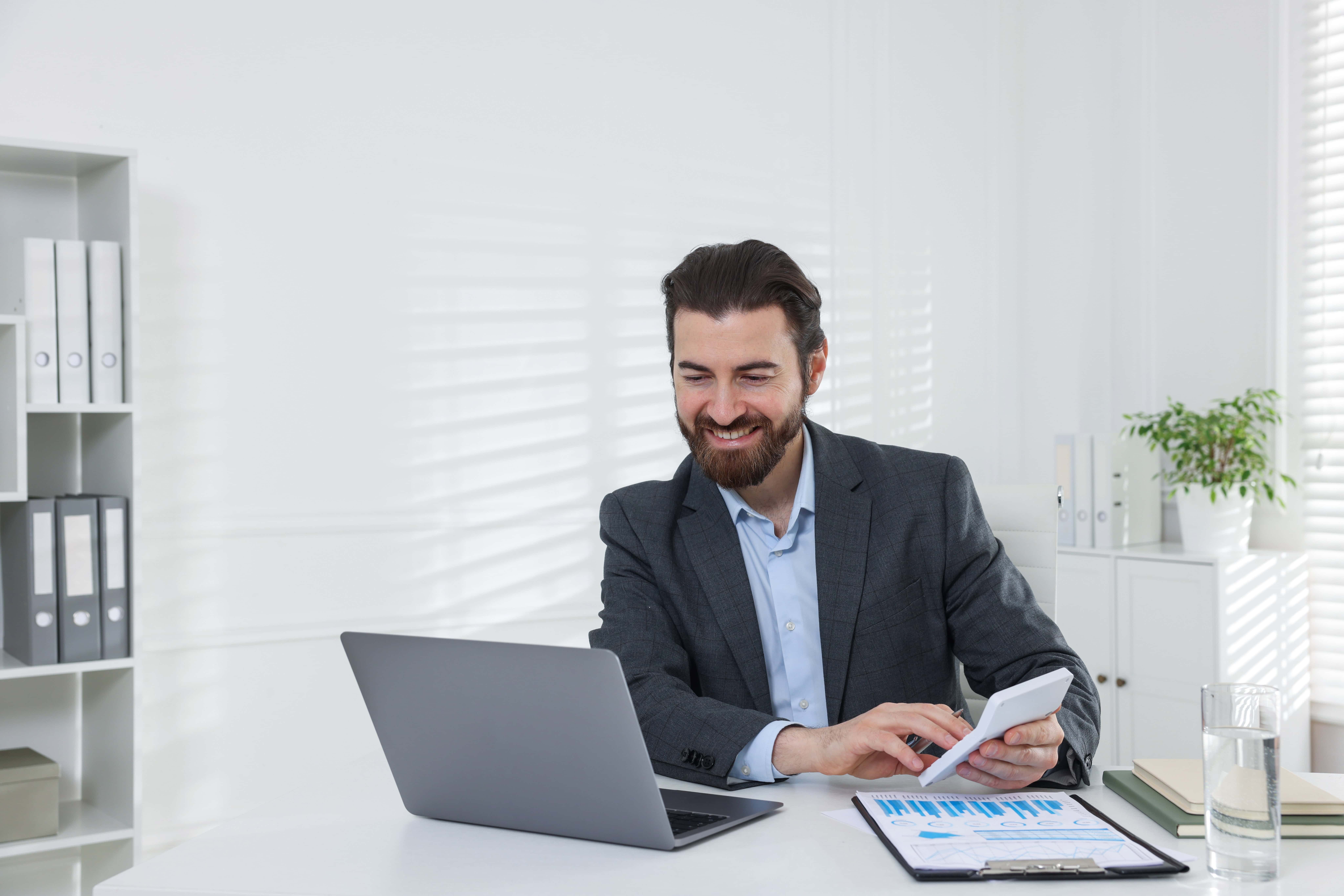 Finance professional in Singapore office reviewing digital expense claims dashboard on laptop.