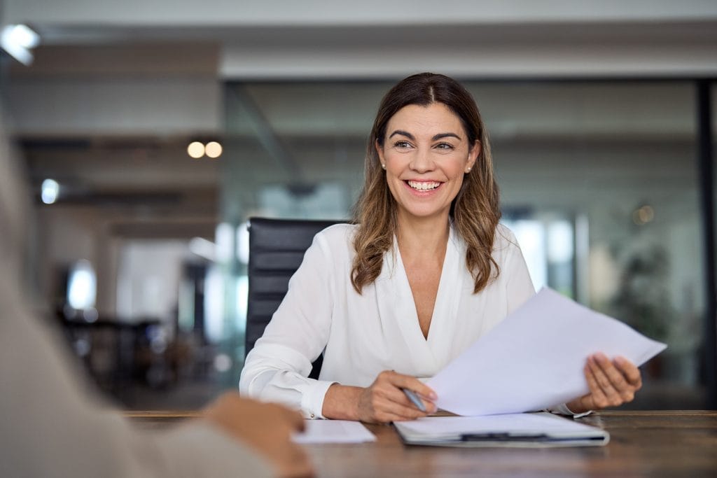 Payroll officer reviewing audit records at a desk in Singapore.