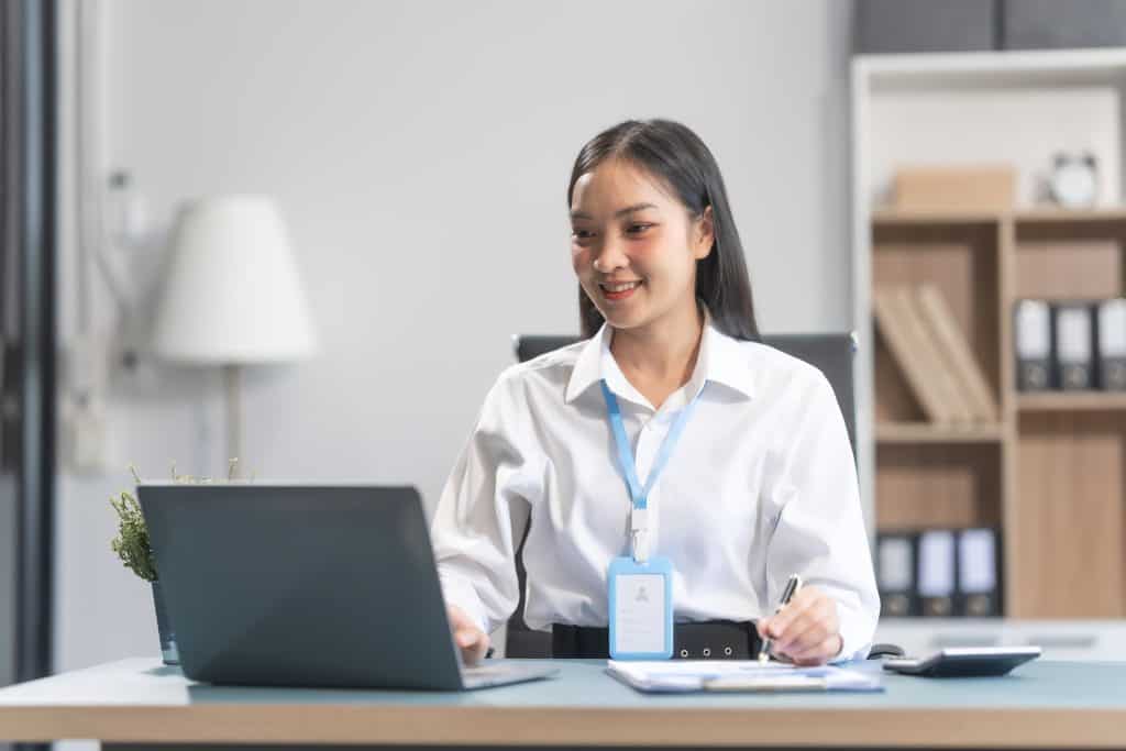 A businesswoman evaluates the cost comparison of in-house vs outsourced payroll in Singapore.