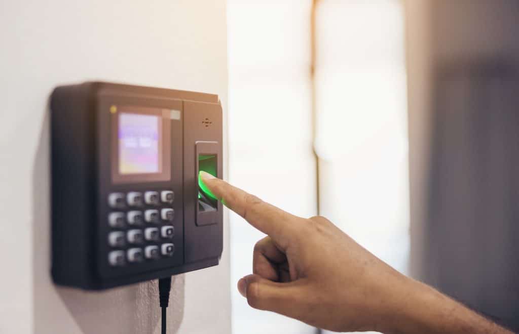 Employee clocking in to work via a time attendance software in Singapore